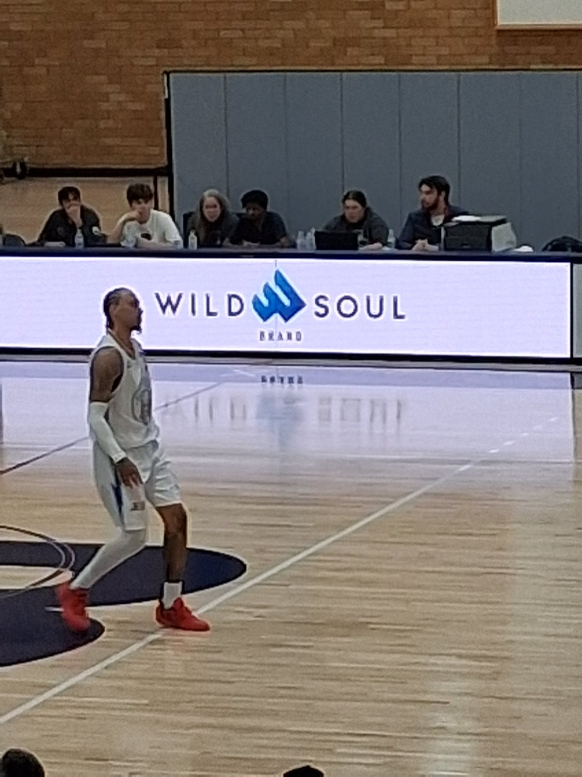 Wild Soul Brand logo on the courtside LED board at a basketball game