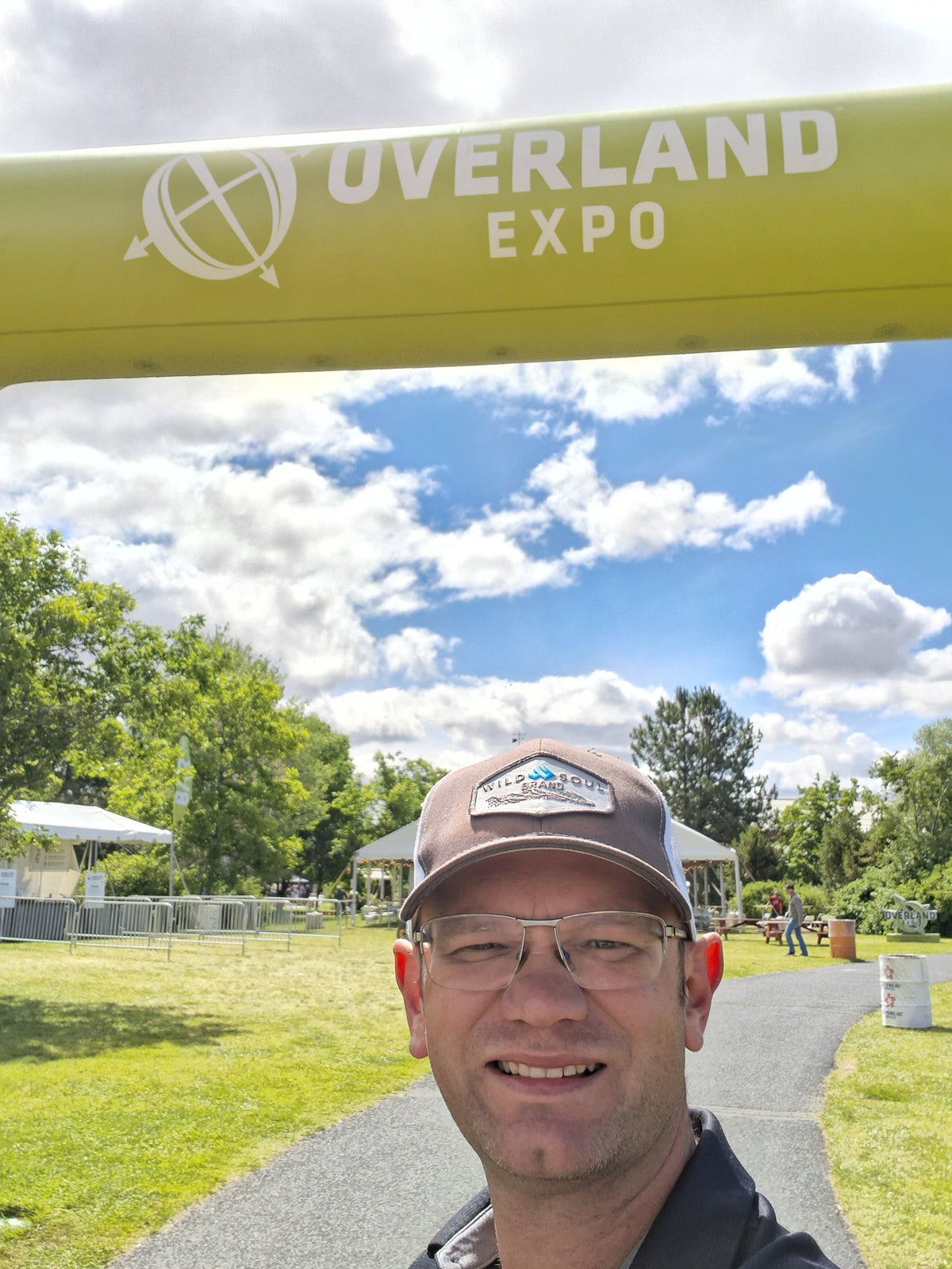 Founder smiling under the Overland Expo arch