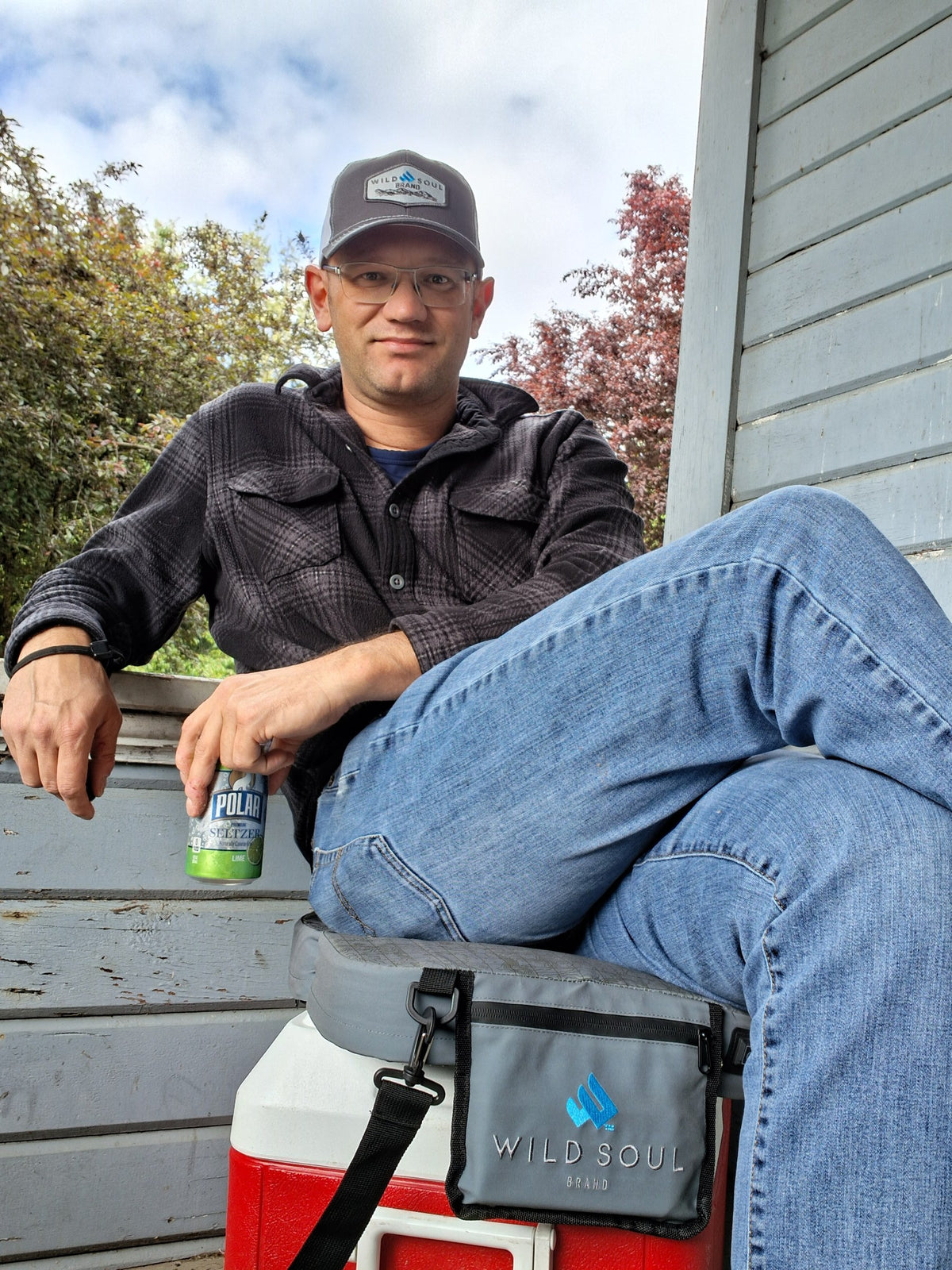 Founder relaxing on a porch with a NextPad Camp carry bag on a cooler